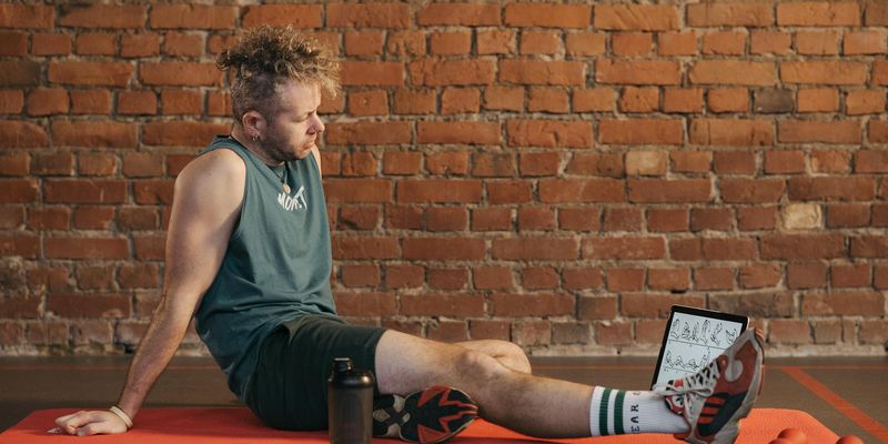 Man performing a deep stretch after a workout session.